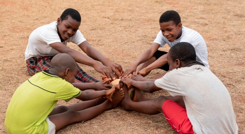 african-children-with-football-ball-sitting